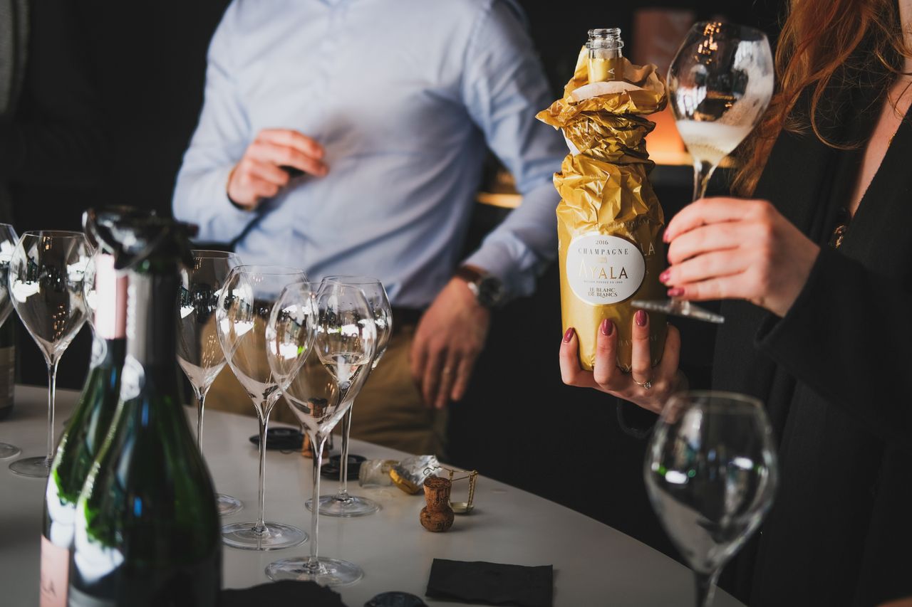 A refined gathering with people enjoying a champagne tasting in Aÿ-Champagne, France.