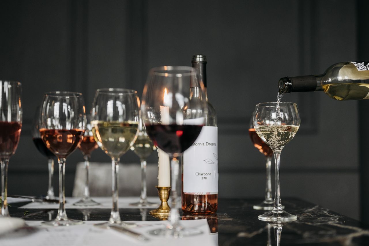 A sophisticated wine tasting arrangement featuring different wine glasses on a dimly lit table.
